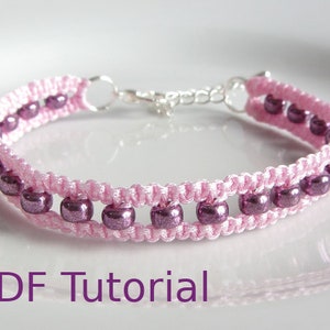 A bracelet that has a 3 row effect. The bottom and top rows are pink cord using macrame knots. The middle row is pink beads. With a metal chain and clasp closure that can extend the length of the bracelet. With PDF Tutorial written on the image.