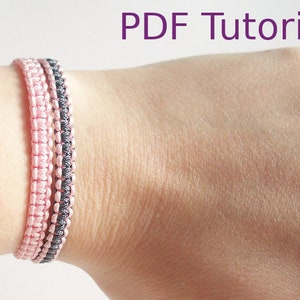 Two macrame square knot bracelets with slider closures are shown worn on a wrist. The left bracelet is in a pink cord and the right one with grey and pink cord. With PDF Tutorial written on the image.