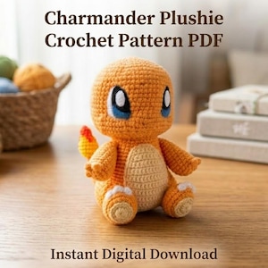 May include: A crocheted orange and cream-colored plushie resembling a lizard-like creature with large blue eyes and a flame-tipped tail. The text Charmander Plushie Crochet Pattern PDF and Instant Digital Download is visible in the image.