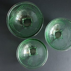 May include: A white ceramic mug with a black handle and the text "But First, Coffee" in a bold, black font. The mug is set against a blurred background, suggesting a cozy setting.