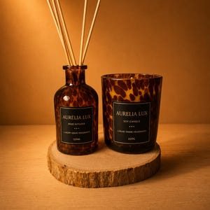 May include: A brown tortoiseshell glass reed diffuser with five wooden reeds and a matching tortoiseshell glass soy candle. Both items feature black labels with the text Aurelia Lux, Luxury Home Fragrance, 120ml for the diffuser and 220g for the candle.