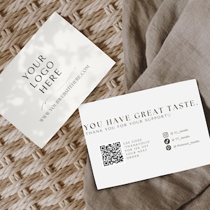 May include: Two white rectangular business cards with black text. One card displays YOUR LOGO HERE and a website URL. The other card reads YOU HAVE GREAT TASTE, THANK YOU FOR YOUR SUPPORT, includes a QR code, social media icons, and a discount code.