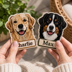 May include: Two embroidered fabric patches featuring dog portraits. The left patch shows a golden retriever with the name Charlie printed on a rectangular tab. The right patch shows a Bernese mountain dog with the name Max printed on a rectangular tab.
