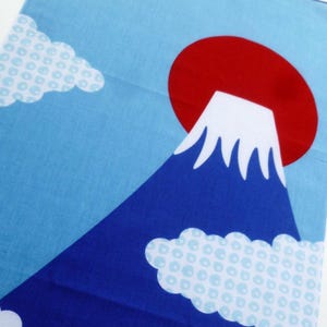 May include: A rectangular fabric panel featuring a graphic print of a dark blue mountain with a white snow-capped peak. A large solid red circle sits behind the mountain against a light blue sky. White clouds with a light blue circular pattern.