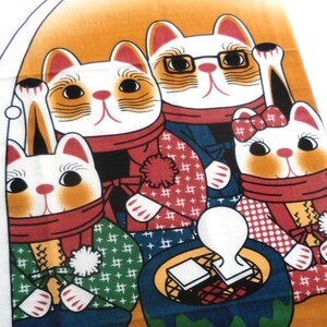 May include: A fabric print featuring four cats wearing winter scarves and clothing, with one cat wearing glasses. Below them are winter boots, snowflakes, and a small white dog inside an igloo on an orange and white background.