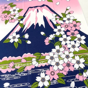 May include: A rectangular fabric textile featuring a graphic illustration of a dark blue mountain with a white snow-capped peak. The scene includes clusters of white and pink cherry blossoms with green leaves, set against a pink and blue sky.