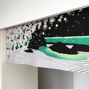 May include: A black and green fabric wall hanging with a white cherry blossom tree and a zen garden design. The text on the hanging reads "Evening bell, Zen garden".