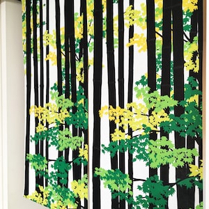 May include: Black and white fabric panels with a repeating pattern of green and yellow leaves and black tree trunks. The fabric panels have the Japanese word "春風" written on them, which translates to "spring breeze".
