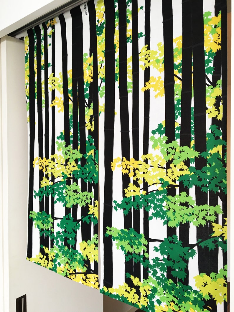 May include: Black and white fabric panels with a repeating pattern of green and yellow leaves and black tree trunks. The fabric panels have the Japanese word "春風" written on them, which translates to "spring breeze".