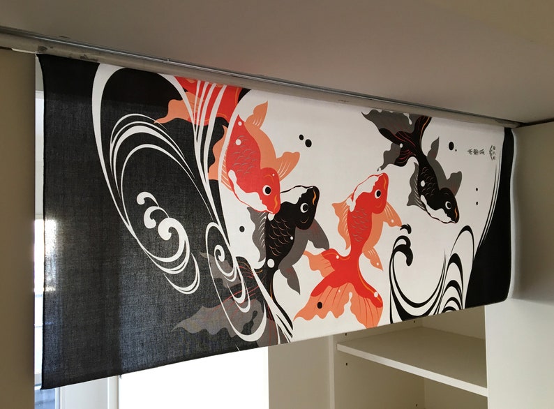 May include: Black and white fabric with a design of red and orange fish swimming in waves. The fabric has the text "幸運" in Japanese characters.