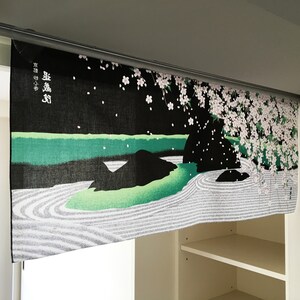 May include: Black and green fabric wall hanging with a Japanese garden scene featuring a white sand zen garden, a green pond, and a cherry blossom tree with pink flowers. The text "葉 嵐 渓" is printed in white on the fabric.