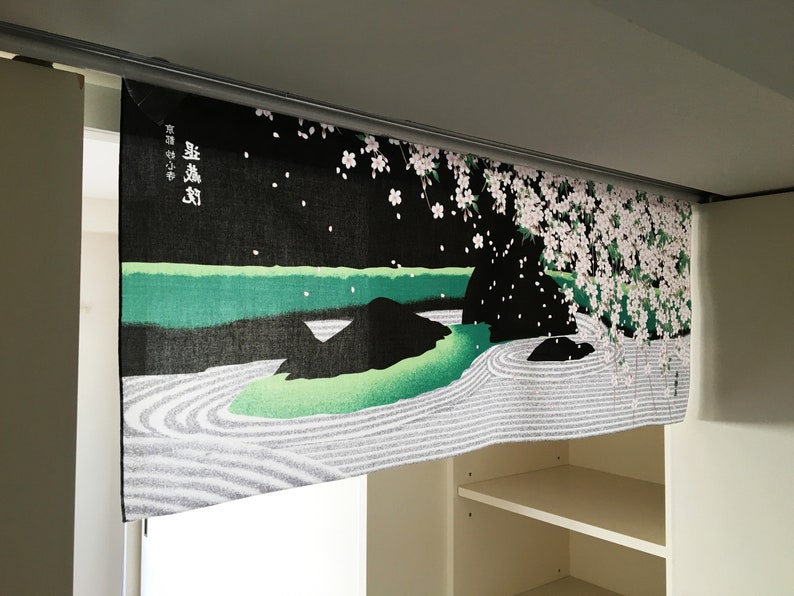 May include: Black and green fabric wall hanging with a Japanese garden scene featuring a white sand zen garden, a green pond, and a cherry blossom tree with pink flowers. The text "葉 嵐 渓" is printed in white on the fabric.