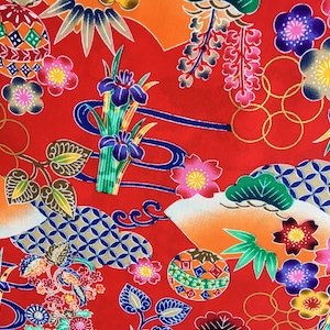 May include: Red fabric with a repeating pattern of colorful Japanese-inspired designs. The pattern includes flowers, leaves, swirls, and geometric shapes.