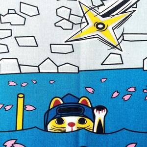 May include: A fabric print featuring a yellow and white cat wearing a blue ninja hood, emerging from blue water scattered with pink cherry blossom petals. Above, a yellow shuriken flies against a light gray background with stone-like shapes.