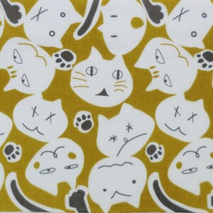 May include: A repeating pattern of white cats with black eyes and noses on a mustard yellow background. The cats are in various poses, some are looking to the left, some to the right, and some are looking straight ahead. The cats are all outlined in black.