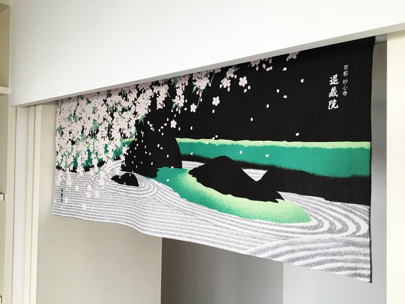 May include: A black and green Japanese-style room divider with a white and pink cherry blossom tree design. The divider has a white and grey sand garden design at the bottom. The text on the divider reads "遠山に桜".