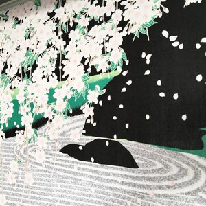 May include: A black and white illustration of a Japanese garden featuring a cherry blossom tree, a rock formation, and a white sand zen garden.