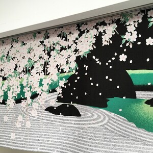 May include: A black fabric panel featuring a Japanese garden design. The panel depicts a white cherry blossom tree with pink flowers, a green pond with a rock, and a white sand garden with a circular pattern.