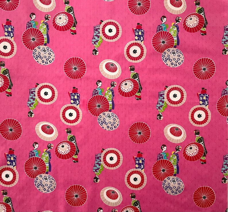 May include: Pink fabric with a repeating pattern of geishas in traditional clothing, holding fans and parasols. The pattern also includes stylized flowers and circles.
