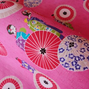 May include: Pink fabric with a repeating pattern of Japanese women wearing kimonos and holding umbrellas. The umbrellas are in shades of pink, white, and blue.