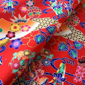 May include: Red fabric with a repeating pattern of colorful flowers, leaves, and geometric shapes. The fabric has a traditional Japanese design.