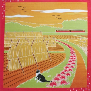 May include: A black and white cat sits in a field of red spider lilies. In the background, there are bundles of hay, a train, and a green hillside. The sky is a pale yellow with a few white clouds.