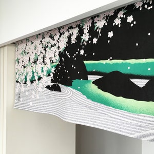 May include: A black and white fabric panel with a Japanese garden design. The panel features a green river, white sand, and a cherry blossom tree with pink flowers.