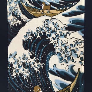 May include: A blue and white wave design with two Shiba Inu dogs riding in wooden boats. The wave is a stylized version of the Great Wave off Kanagawa, a famous Japanese woodblock print.