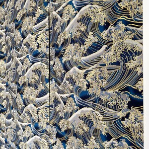 May include: A blue and gold fabric with a repeating pattern of stylized waves. The waves are outlined in gold and have a white foamy crest.