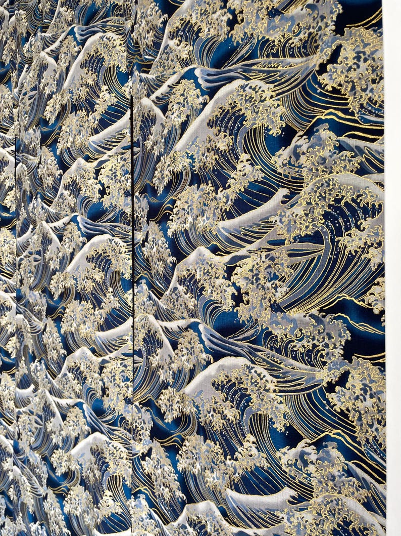 May include: A blue and gold fabric with a repeating pattern of stylized waves. The waves are outlined in gold and have a white foamy crest.