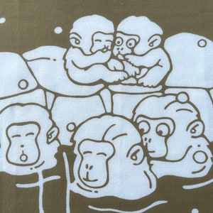 May include: A fabric with a repeating pattern of white cartoon monkeys on a brown background. The monkeys are in various poses, some hugging and others with surprised expressions. The design has a playful and whimsical feel.