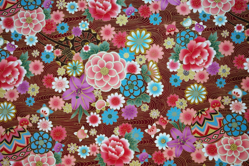 May include: A fabric pattern featuring a deep maroon background with intricate gold wavy lines. The design includes a dense arrangement of colorful flowers in shades of pink, red, light blue, and purple, interspersed with small geometric patterned spheres.