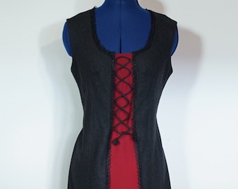 Traditional dress made of loden, black and red, with lacing and border