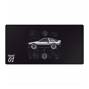 May include: Black rectangular desk mat featuring a white and silver car design with blueprint details. The text "TOUGE 01" is in white on the left side. The car is a coupe with a hatchback.