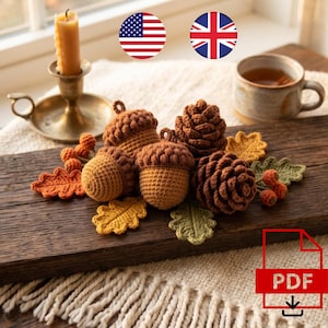 May include: A collection of crocheted autumn-themed items including two brown acorns with textured caps, two dark brown pinecones, and several small crocheted leaves in shades of orange, yellow, and green, along with a small cluster of orange berries.
