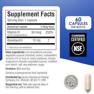 May include: A supplement facts label for a bottle containing 60 capsules. The label lists Vitamin D and Apoaequorin, along with other ingredients including milk and soy. A US dime coin is placed next to a single beige capsule for size reference.