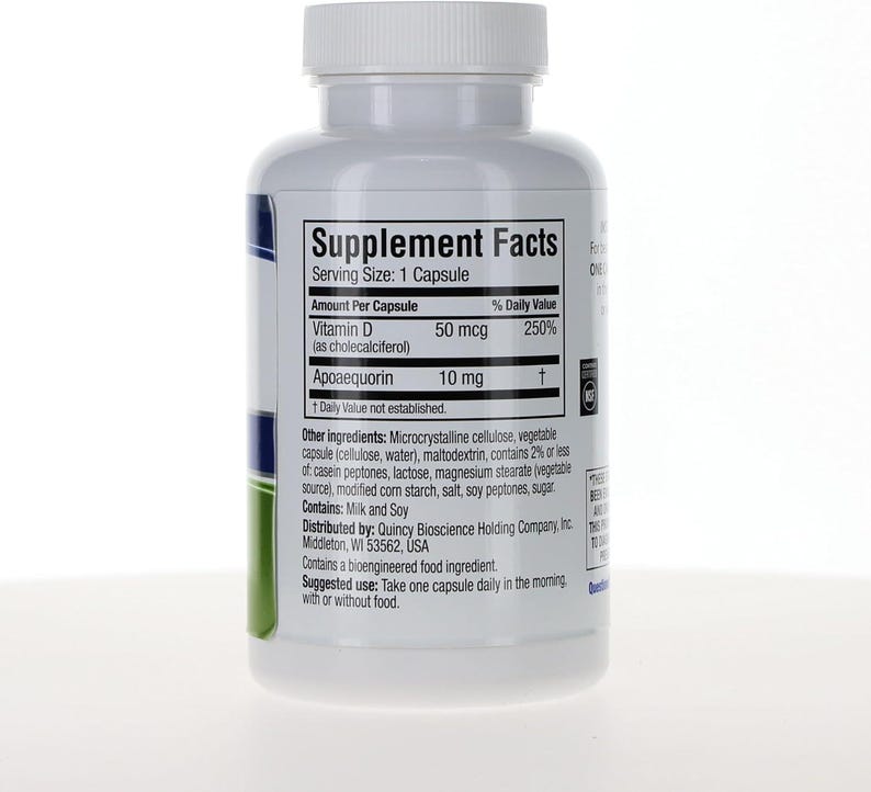 May include: A white plastic supplement bottle with a screw-top lid featuring a Supplement Facts label. The label lists Vitamin D 50 mcg and Apoaequorin 10 mg per capsule, with ingredients including microcrystalline cellulose, milk, and soy.
