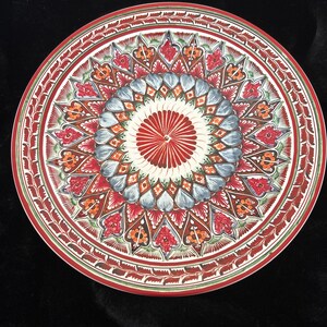 This is a Pottery Barn Mezze Red stoneware decorative plate featuring an intricate red, blue, and orange floral geometric pattern.