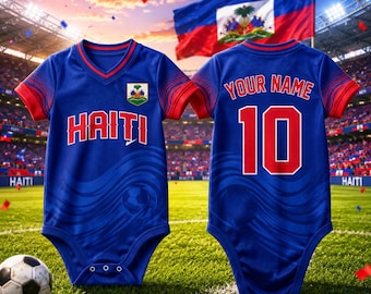 May include: Blue and red baby bodysuit with "HAITI" printed on the front and the number "10" on the back. The bodysuit features the Haitian flag and a soccer ball design. A soccer ball rests on the grass in front of the bodysuit.