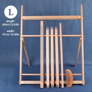 May include: A light-coloured wooden weaving loom frame with a length of 60cm and a width of 47cm. The set includes a long grooved stick, three flat wooden shuttles with notched ends, a smooth wooden rod, and a small wooden hair comb.