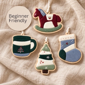 May include: Four felt ornaments with wooden frames, including a rocking horse, a mug, a Christmas tree, and a stocking. Each piece features embroidery and a hanging loop. A circular tag with the text Beginner Friendly is included.