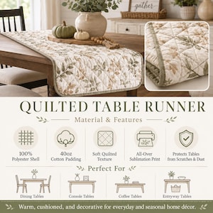 May include: A rectangular quilted table runner featuring a botanical print of green and brown leaves on a cream background. The runner has a soft quilted texture, a 100% polyester shell, and 40oz cotton padding. It is designed for dining tables.