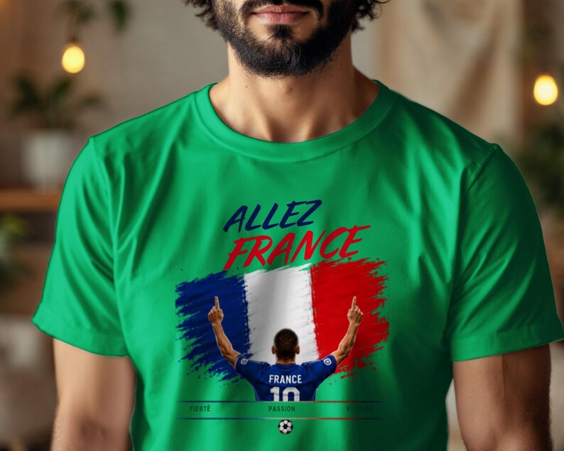 May include: A bright green short-sleeved t-shirt featuring the text "ALLEZ FRANCE" in blue and red. Below the text is a graphic of the French flag and a soccer player wearing a blue jersey with "FRANCE 10" on the back, with the words "FIERT&Eacute;", "PASSION", and "VICTOIRE" below.