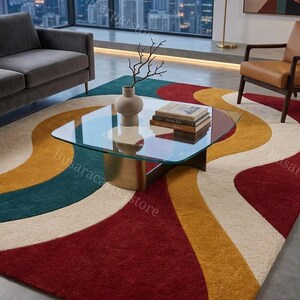 Può includere: Un grande tappeto caratterizzato da un audace motivo astratto con bande curve e fluide nei colori rosso intenso, giallo senape, verde ottanio e crema. Il tappeto presenta un pelo spesso e strutturato che copre gran parte del pavimento.