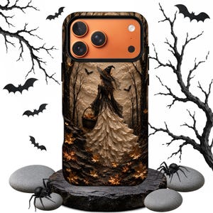 May include: A smartphone case featuring a graphic illustration of a figure in a witch hat and a long, layered skirt walking through a dark forest with autumn leaves. The case has an orange camera module and is surrounded by black bat and tree silhouettes.