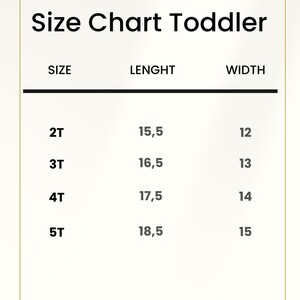 May include: A white toddler size chart with black text. The chart lists sizes 2T, 3T, 4T, and 5T with corresponding length and width measurements in inches. The header reads Size Chart Toddler, and the footer states Measurements in inches.
