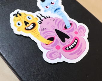 Three-Headed Monster Sticker - Grotesque Skull with Yellow & Blue Creatures, Creepy Cute Decal
