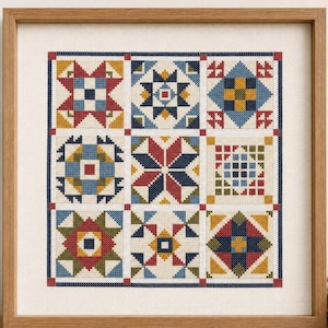 May include: A square framed cross-stitch sampler featuring a grid of nine distinct geometric quilt block patterns. The embroidery uses a palette of red, navy blue, mustard yellow, and olive green thread on a cream-colored fabric background.