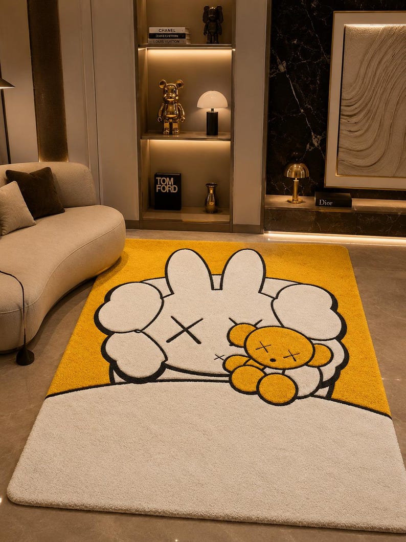 May include: A rectangular yellow and white rug featuring a cartoon character design. The rug has a large white character with black cross-shaped eyes and a small yellow teddy bear. The rug is placed on a light-colored floor.