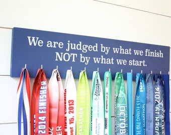 Medal Display - We are judged by what we finish NOT by what we start. - Large - Running / Triathlon / Ultra / Obstacle Race